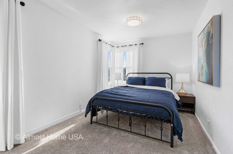 Queen bed in main bedroom in furnished rental in Sturgeon Bay, WI.