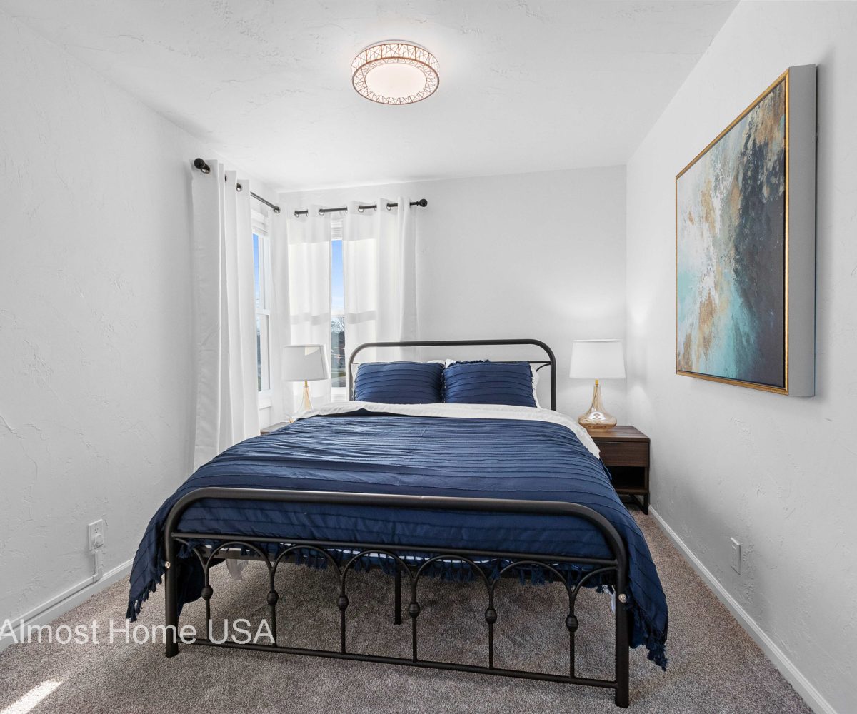 Queen bed and wall art in furnished rental located in Sturgeon Bay, WI.