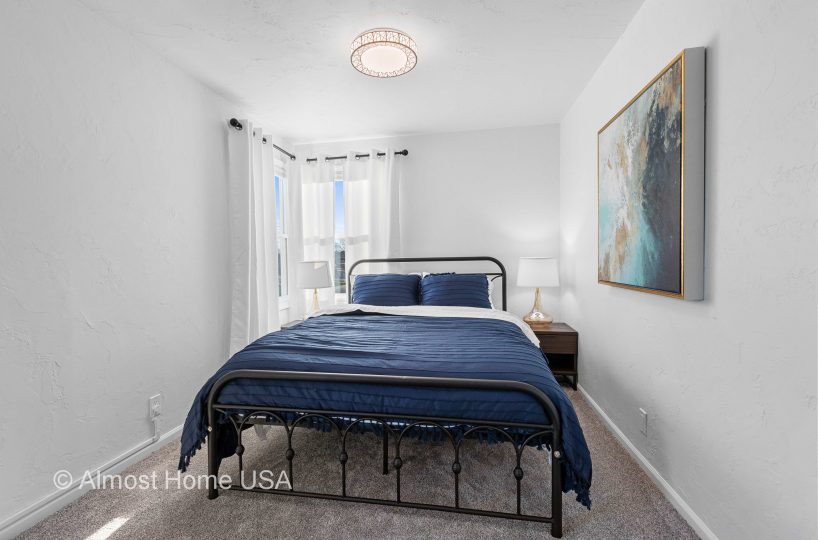 Queen bed and wall art in furnished rental located in Sturgeon Bay, WI.