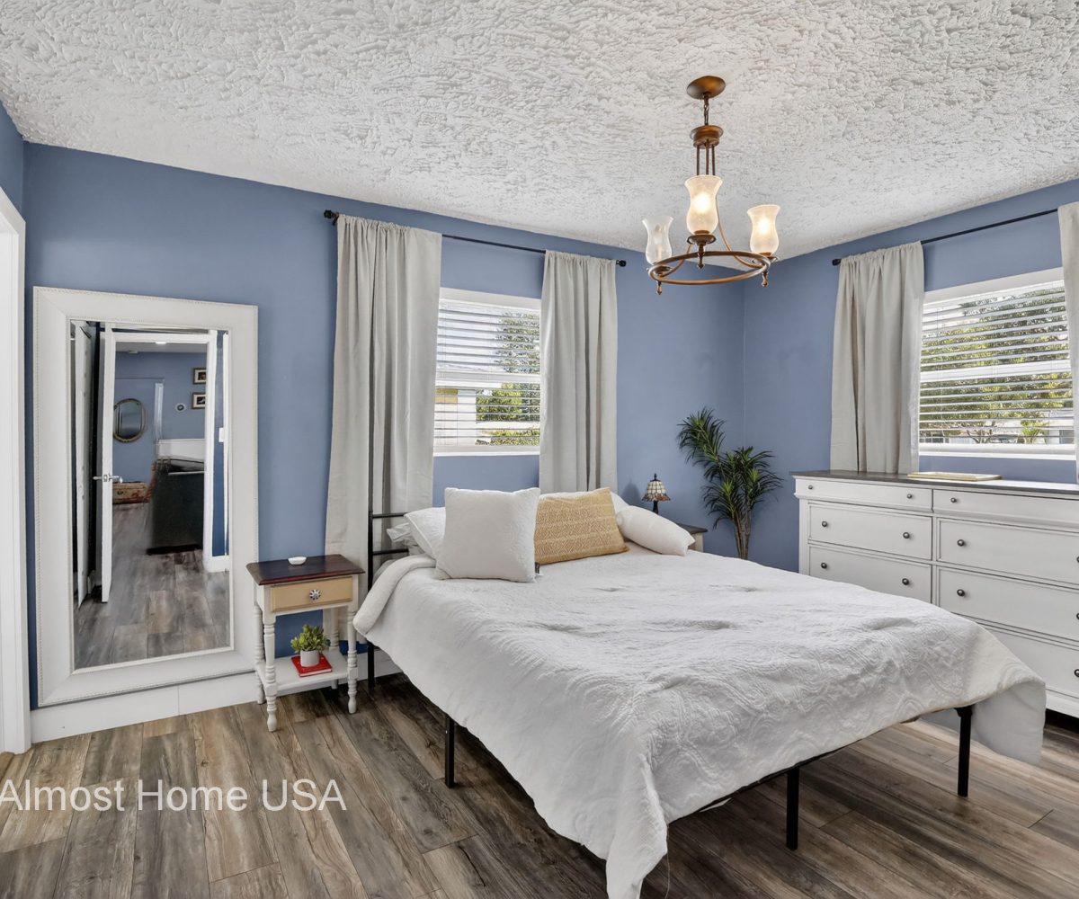 Queen bed in furnished bedroom at furnished home in Miami, FL.