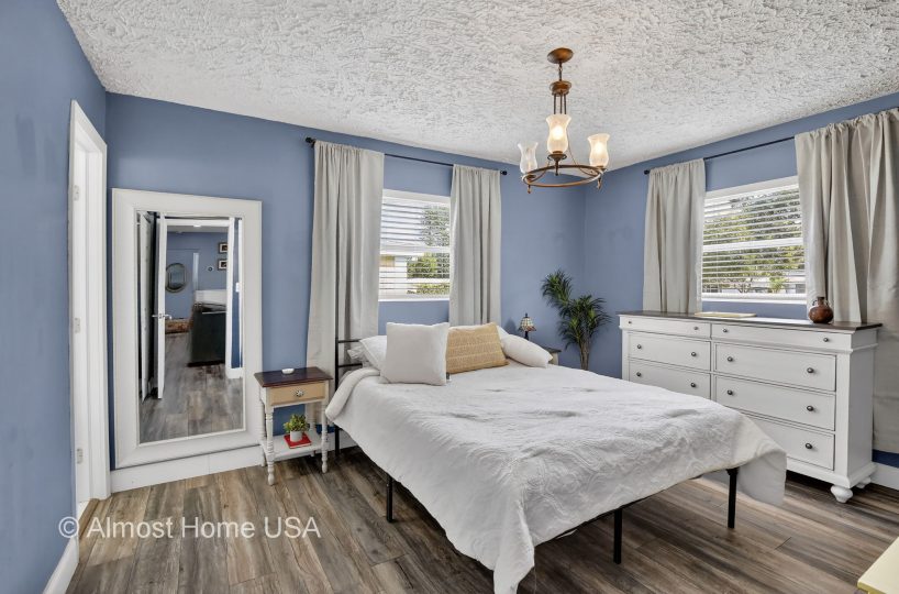 Queen bed in furnished bedroom at furnished home in Miami, FL.