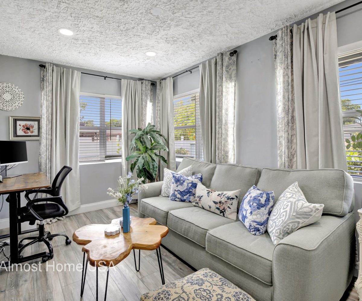 Workstation and couch in furnished home located in Miami, FL.