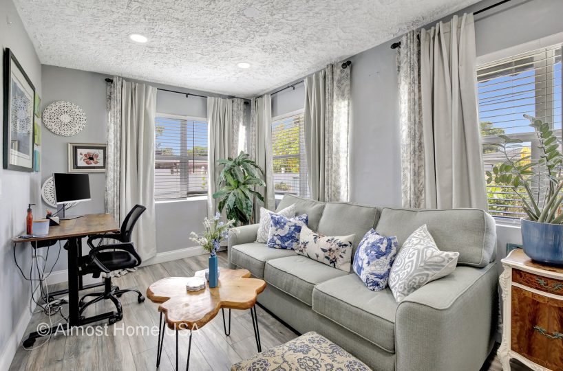 Workstation and couch in furnished home located in Miami, FL.