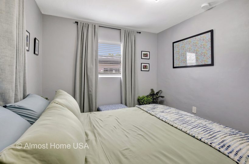 Queen bed in furnished home located in Miami, FL.