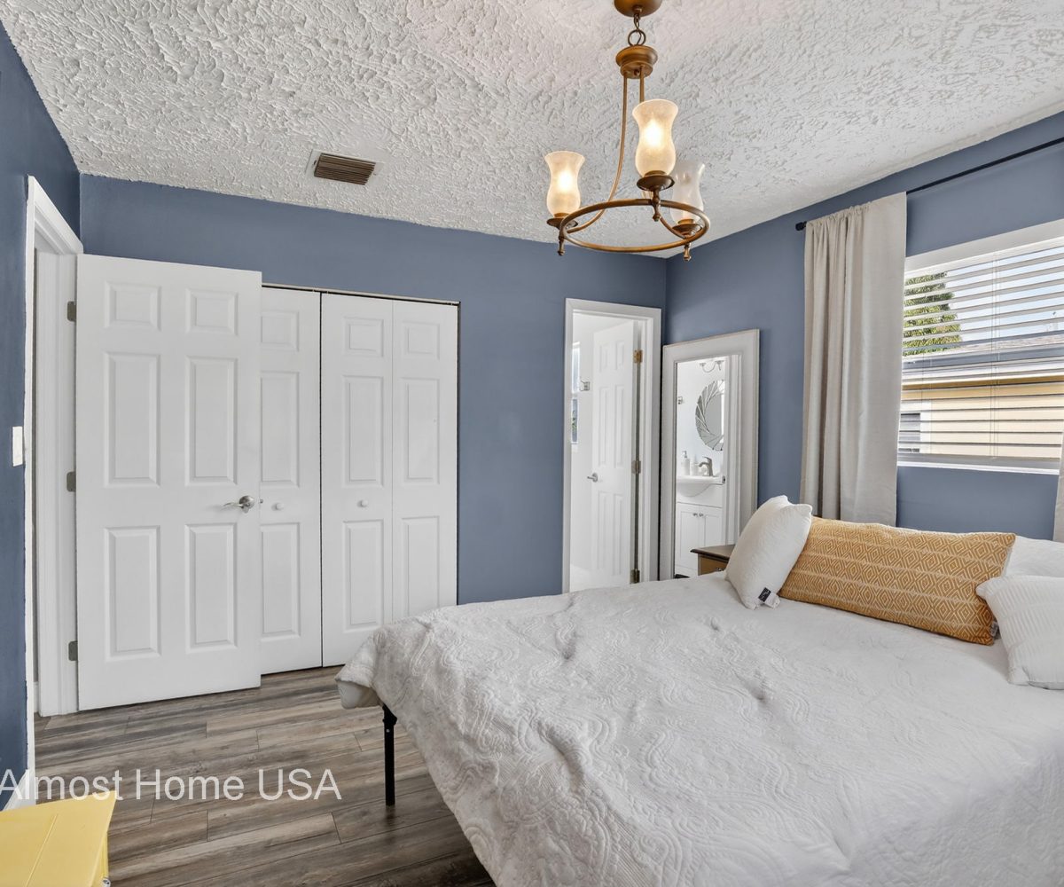 Queen bed in furnished bedroom located in Miami, FL.