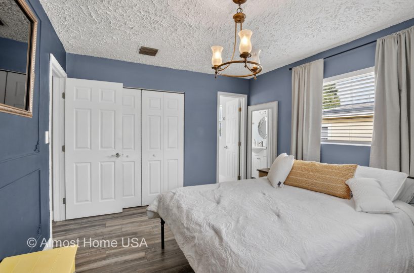 Queen bed in furnished bedroom located in Miami, FL.