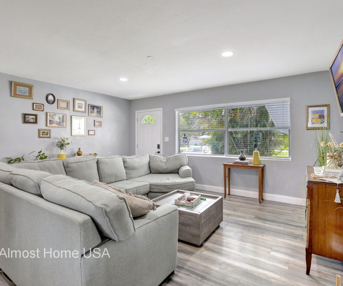 Large couch in furnished living room in furnished home located in Miami, FL.