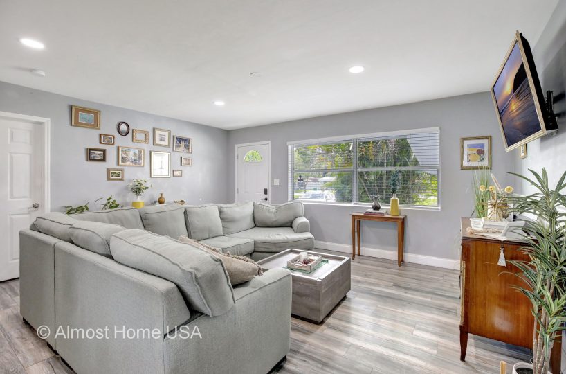 Large couch in furnished living room in furnished home located in Miami, FL.