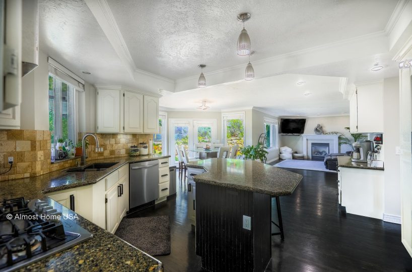 Kitchen and living area in furnished 5 bedroom home in Holladay, UT.