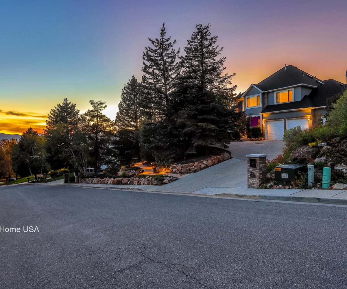 Front exterior and mountain view at furnished 5 bedroom home in Holladay, UT.