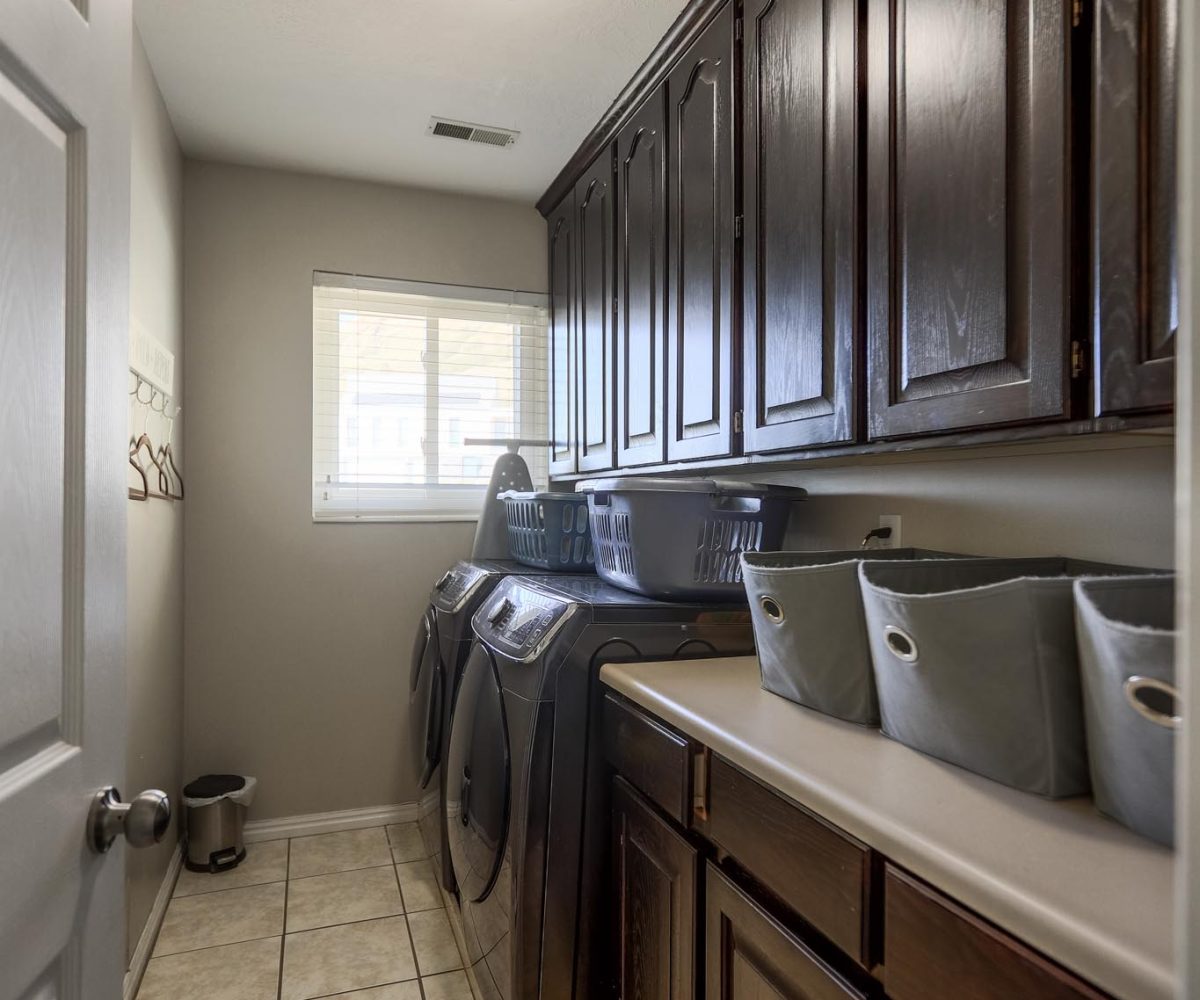 Laundry room in furnished five bedroom home in Holladay, UT.
