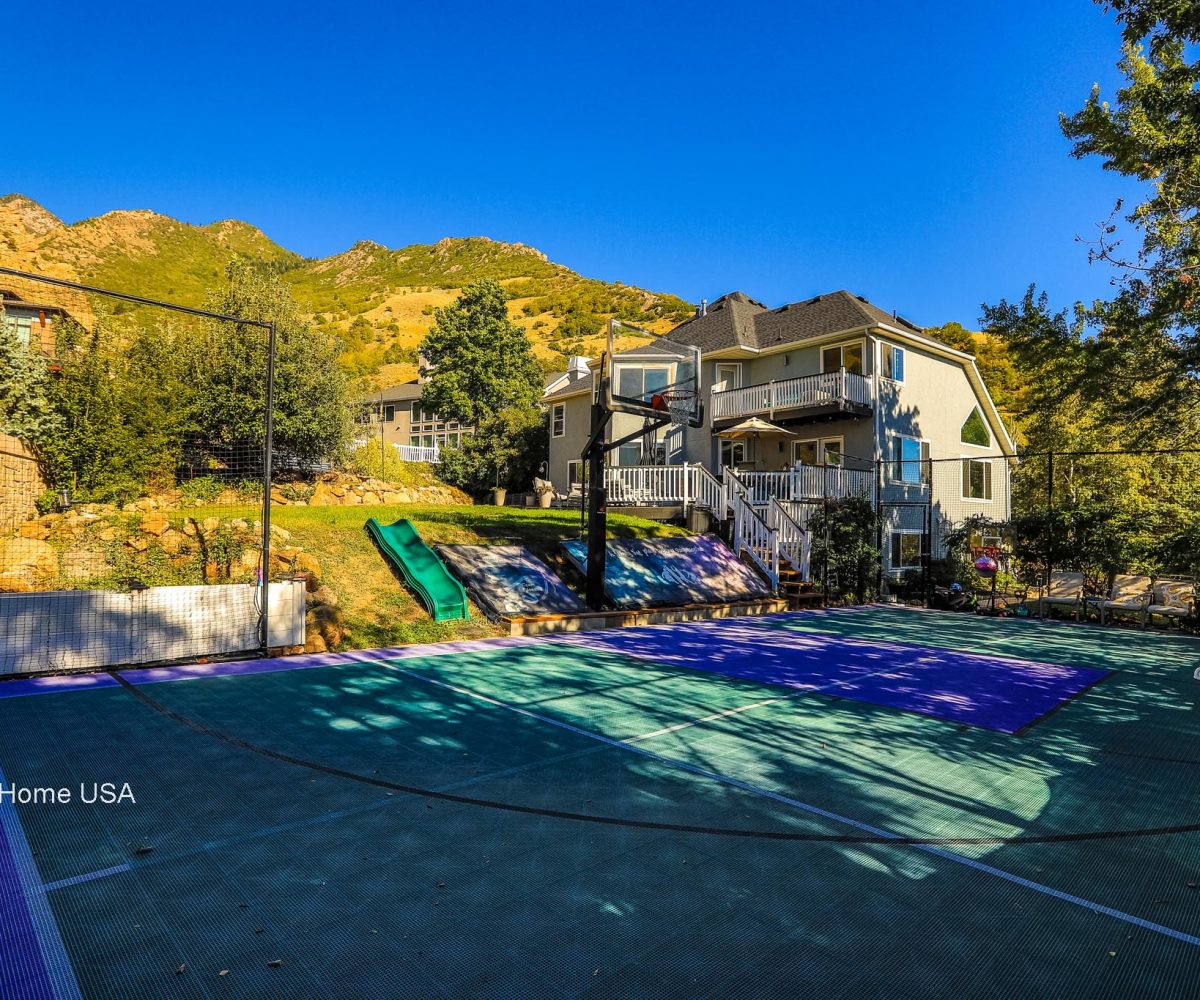 Basketball court and backyard at furnished home in Holladay, UT.
