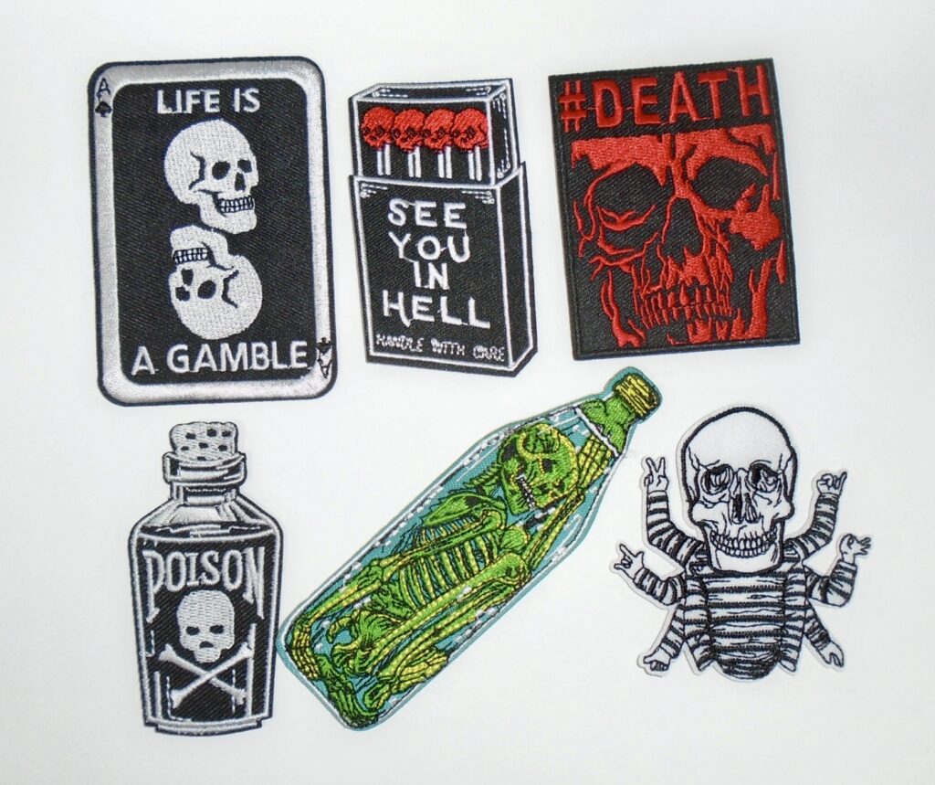 Set of six skull iron on patches with card, matches, death, poison, green skull, and crossed arms designs