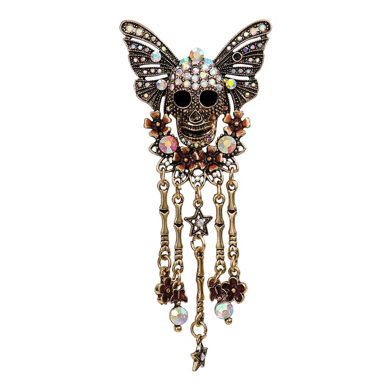 Butterfly skull rhinestone brooch with gold plated finish and dangling bone accents
