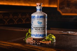 Ceramic bottle with botanicals on bar - Gunpowder Gin
