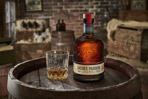 Bottle and glass horizontal - Jacob's Pardon Whiskey