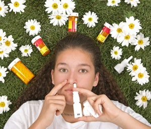 girl on grass with medicines for seasonal allergies