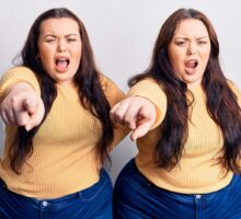 Obesity: angry overweight twins who are pointing