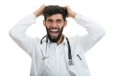 Angry and frustrated doctor pulling out his hair