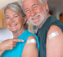 Senior citizen couple smiling after a vaccination