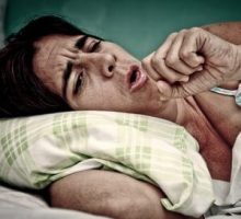 a person trying to get some sleep is kept awake coughing