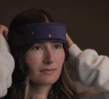 woman puts on SpatialSleep headband for defeating insomnia