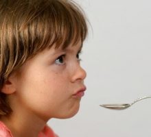child and medicine spoon