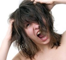woman yelling with her fingers in her hair, itchy scalp