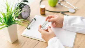 doctor holding pills represents lifesaving potential of old drugs