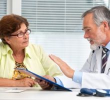 a male doctor talking to a female patient