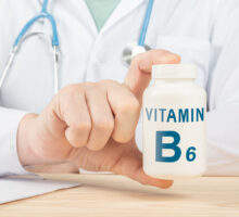 Doctor holds Vitamin B6 bottle