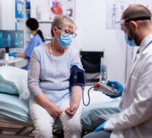 doctor measuring blood pressure in hospital emergency department