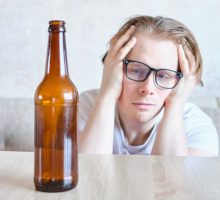 Man eyes empty brown bottle, wishing for hangover remedy that works