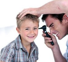 a boy gets an ear exam