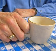 Elderly Hand With Coffee Cup