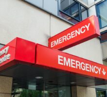 Emergency department with red signs saying EMERGENCY