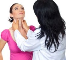 Doctor endocrinologist checking tyroide goiter of pregnant woman and holding hands on her throat