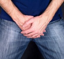 man holding crotch because of erectile dysfunction