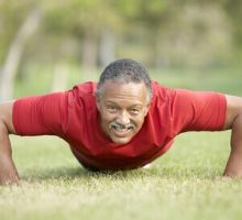older african american man doing pushups in the park, exercise