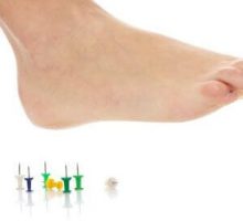 a foot above several upright thumb tacks