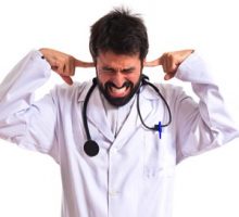 frustrated doctor with his fingers in his ears