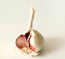 a garlic bulb split open to show the cloves