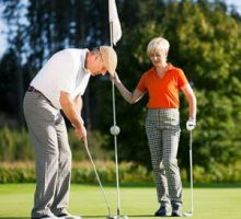 a senior couple playing golf