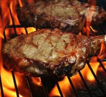 grilled steaks on the grill with flames, grilled meat