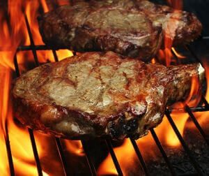 grilled steaks on the grill with flames, grilled meat, carnivore diet