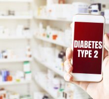 smart phone reads Diabetes type 2 in front of pharmacy shelves with pills responsible for the diabetes epidemic