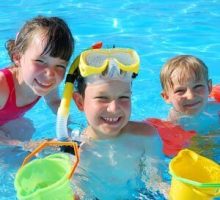happy children swimming in summertime