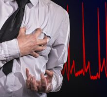 Man clutches chest having a heart attack