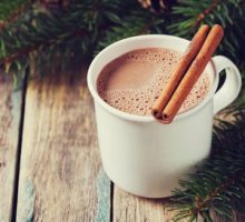 Cup of hot cocoa with cinnamon sticks