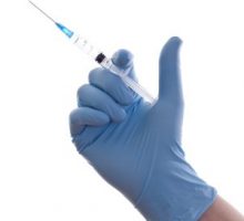 Hand of a doctor with the syringe